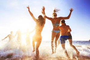 A group of friends on the beach enjoying all the Things To Do On Spring Break.